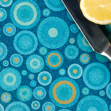 Blue patterned cutting board with a knife and lemons on a white background