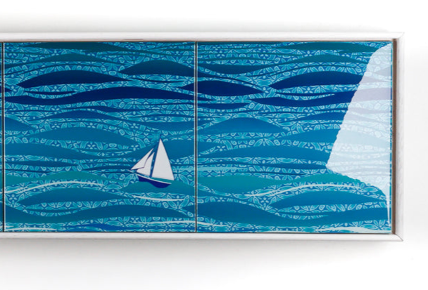 Decorative tile mural with blue wave patterns and a sailboat on a white background
