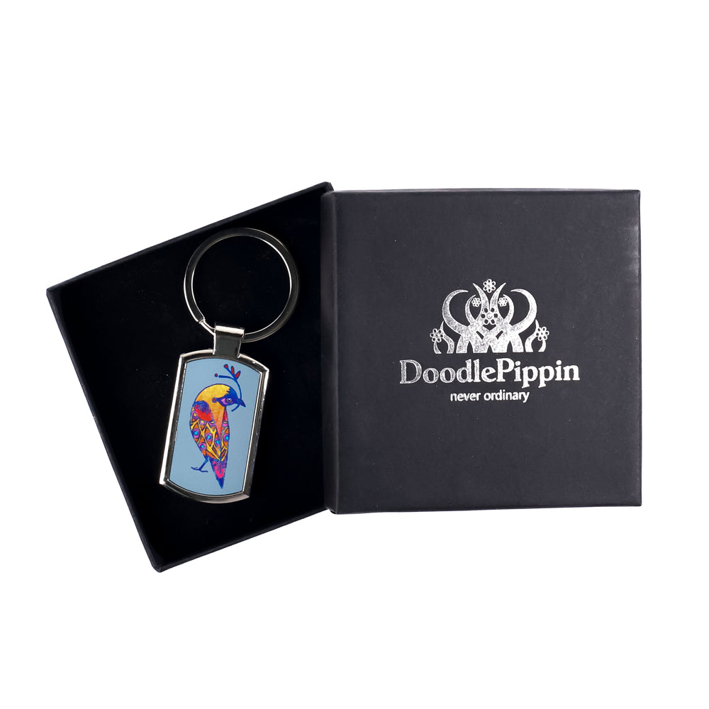 A multicoloured lovebirds keyring with a millefiori print inlay, presented in a black DoodlePippin box with silver embossing and a velvet liner.